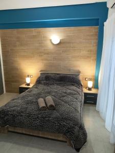 Ένα ή περισσότερα κρεβάτια σε δωμάτιο στο GM 7 ROOMS KENTRO στην καρδιά της πόλης