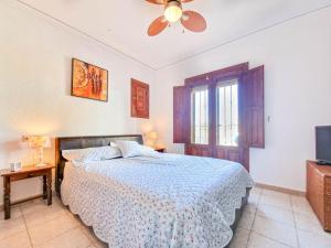 a bedroom with a bed and a ceiling fan at Casa Fortunata in Benitachell +4 photos
