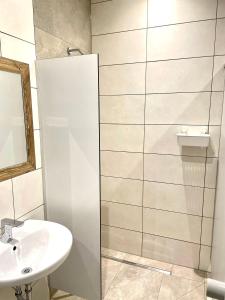 a white bathroom with a sink and a mirror at Camping Lechtal in Vorderhornbach