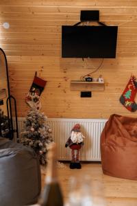 a room with a christmas tree and a tv on the wall at SMART Via Kazbegi in Stepantsminda