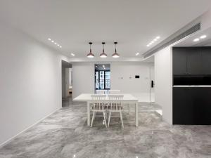 a dining room with a white table and chairs at Shanghai Jing'an Art Pavilion-Large 3Bedrooms South-north Direct Sunny House in Shanghai