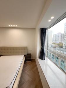 a bedroom with a bed and a large window at Shanghai Jing'an Art Pavilion-Large 3Bedrooms South-north Direct Sunny House in Shanghai