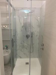 a shower with a glass door in a bathroom at Candia House in Rome