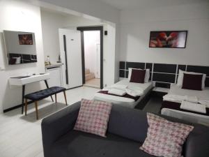 a living room with a couch and a table at WB Weekend Otel in Bodrum City