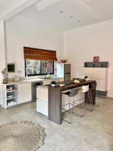 a kitchen with a large wooden table in a room at Residence Laurada - Tropical 2 Bedrooms Villa with Private Pool in Pointe aux Piments