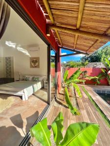 a bedroom with a view of a bed on a patio at Residence Laurada - Tropical 2 Bedrooms Villa with Private Pool in Pointe aux Piments
