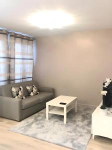 a living room with a couch and a table at Appartement moderne au centre de Paris, 3ème in Paris