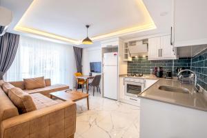 a kitchen and living room with a couch and a table at Yosun Apart in Kaş +97 photos