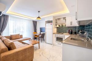 a kitchen and living room with a couch and a table at Yosun Apart in Kas