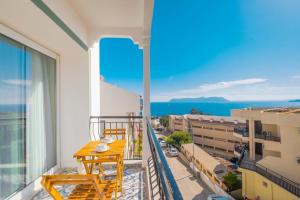 a balcony with a table and chairs and a view of the ocean at Yosun Apart in Kaş