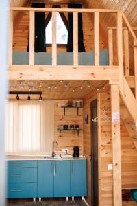 a kitchen with a bunk bed in a wooden house at Via Kazbegi in Stepantsminda