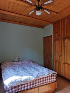 a bedroom with a bed with a ceiling fan at LEMON TREE GARDEN near Mirtos beach in Bekatoráta