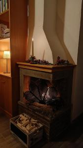 a fireplace with a candle on top of it at Campo Felice Apartment in Collimento