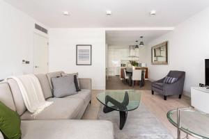 a living room with a couch and a glass table at Beautiful 2-Bed Apartment in Central London in London