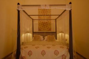 a bedroom with a bed with a canopy at Treasure Rock in Kirinda