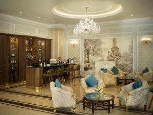 a hotel lobby with a bar and a chandelier at MerPerle Dalat Hotel in Da Lat