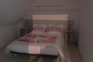 a bedroom with a large bed with pillows at Gite à la ferme du chateau in Saint-Dolay