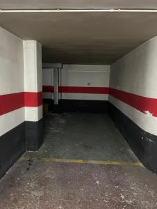 an empty parking garage with red and white stripes at Apartamento en Zaragoza con parking in Zaragoza