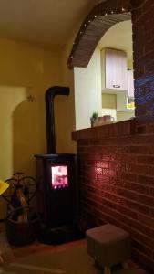 a living room with a brick stove in a kitchen at Vikendica Alisa in Doboj
