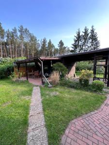 a pavilion with a picnic table in a park at Waldhaus Jellen in Dobbertin