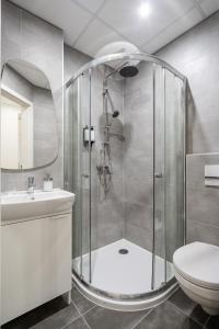 a bathroom with a shower and a toilet and a sink at A13- Deluxe Apartments, Best Location, by BQA in Budapest