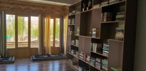 a living room with book shelves filled with books at Sankar Residency in Leh