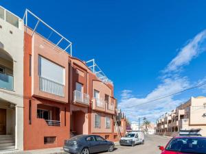 two cars parked on a street next to buildings at CABO DE LAS ÁGATAS in El Cabo de Gata