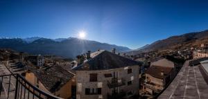 a view of a city with the sun in the sky at La Svolta Foresteria in Chiuro