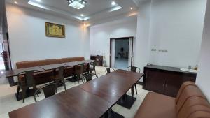 a conference room with tables and chairs in it at Mami Hotel in Solok