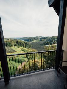 a balcony with a view of the rolling hills at GUESTHOUSE RIEGERSBURG - Das Haus der guten Geister in Riegersburg