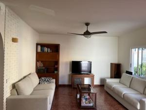 a living room with two couches and a tv at Casa mediterránea junto al mar. in Chilches