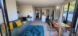 a living room with a couch and a table at Comfy 2 bed appt in central werribee in Werribee