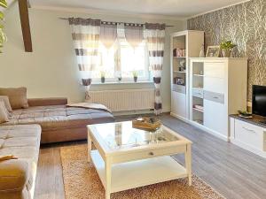 a living room with a couch and a coffee table at Ferienwohnung Sonnenring in Lübbenau