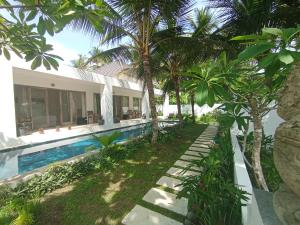 an exterior view of a villa with a swimming pool at Deepblue vila in Pulukan