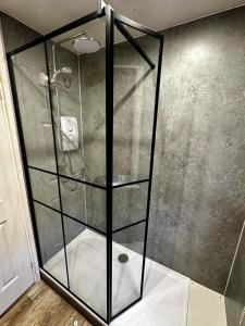 a shower with a glass enclosure in a bathroom at Flanders Fields in Dingwall