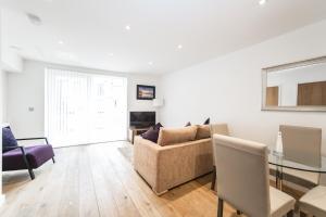 a living room with a couch and a table at StayInn Greenwich in London