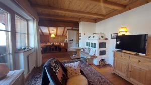 a living room with a flat screen tv and a couch at Haus Annemarie in Oberndorf in Tirol