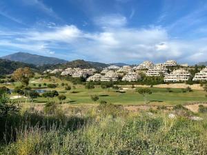 a view of a golf course with a resort at Appartement (4p) in Luxury Capanes Del Golf in Benahavís