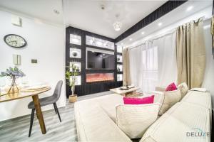 a living room with a couch and a table at Opulent 1BR at Manchester Tower Dubai Marina by Deluxe Holiday Homes in Dubai