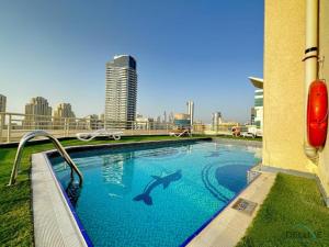 a swimming pool with a shark on the side of a building at Opulent 1BR at Manchester Tower Dubai Marina by Deluxe Holiday Homes in Dubai