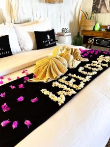 a bed with a bunch of flowers on it at Tropical Glamping Nusa Penida Diamond Beach - Cliff Side Edge in Nusa Penida