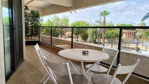 a table and chairs on a balcony with a view at חדרי בוטיק B.Y in Bet Sheʼan