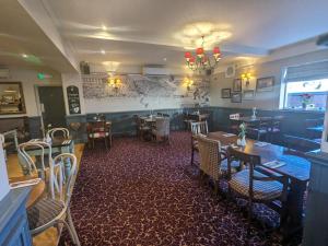 a dining room with tables and chairs in a restaurant at The Seal in Selsey