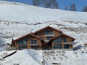 a house on a hill covered in snow at Le 4 in Les Deux Alpes
