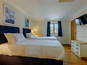 a bedroom with a large bed and a television at 2 Bed in Westward Ho 89868 in Westward Ho