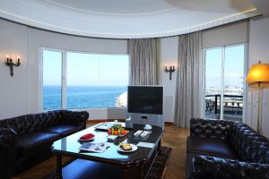 a living room with a couch and a table at Warwick Palm Beach Hotel in Beirut