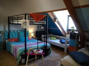 a bedroom with a bunk bed and a table at Villa avec piscine chauffée Périgord Dordogne in Marnac +31 photos