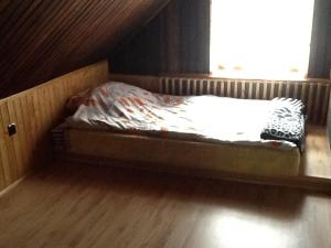 a small bed in a room with a window at Lakefront House & Sauna Mazury, quiet beautiful village, domekprzytulny in Ełk