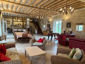 a living room with couches and chairs and a table at LA CHARMILLE Jolie maison de campagne 14 personnes piscine calme in Entrains-sur-Nohain