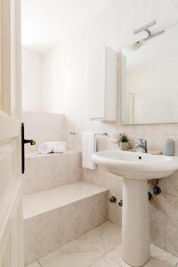 a white bathroom with a sink and a mirror at Hotel Da Raffaele in Ischia